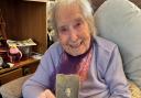Margaret from Swindon holds a photo of her teenage self who served in the Royal Air Force during the Second World War