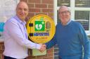 Malmesbury League of Friends chairman David Hide (right) hands over the defibrillator to Jamie Howes from Hilditch Group