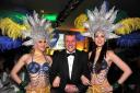 Wiltshire Business Awards - Presenter Graham Rogers of BBC Wiltshire with showgirls Danni Marsh and Rebecca Hackett before taking to the stage for the awards at Center Parcs -Longleat  GP300-9.Photo GlennPhillips www.gphillipsphotography.com.