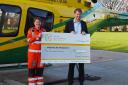 Excalibur CEO Peter Boucher hands over the cheque to the air ambulance