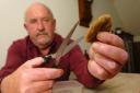 Bob Newman, shows how the teabags should be cut go get the leaves out