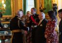 Sgt Tom Hughes chats with King Charles after being honoured for his marksmanship in the Royal Marines