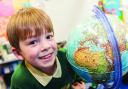 Barnaby exploring the globe at Longleaze Primary School