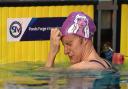 Carlin takes off her swim cap after claiming gold in 800m