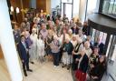 Staff, former staff, and volunteers celebrate the 70th Anniversary at a history centre party.