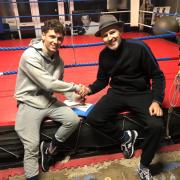 Swindon’s Lewis Roberts (left) with trainer Paddy Fitzpatrick after signing his first professional deal during November 2022