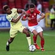 Swindon Town's Ellis Iandolo battles with an Arsenal U21 player during the EFL Trophy clash in 2021