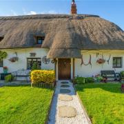 The cottage's thatched roof is enchanting.