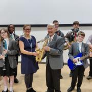 Colin Abrams, the father of the late musician Frank Abrams, hading over two saxophones to Great Western Academy in his honour
