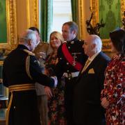 Sgt Tom Hughes chats with King Charles after being honoured for his marksmanship in the Royal Marines