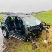 A car that has been 'split in half' following a crash with a coach
