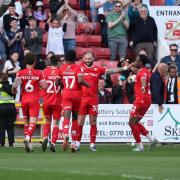 Swindon players celebrate the third goal