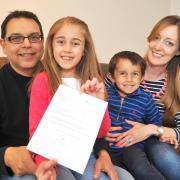 Eight-year-old Isabella Davey with her family and the letter from David Cameron