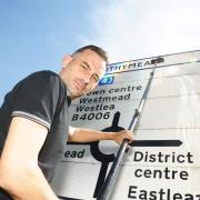 Rob Panther gets down to work cleaning street signs around Swindon