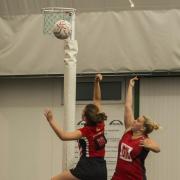 Raychem D’s Chloe Ashman (left) and Delta Reds B’s Ami Miller contest below the net during their Division Three clash at the Dorcan Dome on Saturday
