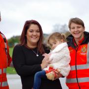 Sam Pothecary and her daughter Mia with Wiltshire Air Ambulance Critical Care Paramedics Richard Miller and Louise Cox