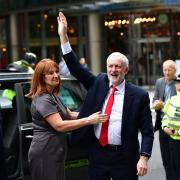 Labour leader Jeremy Corbyn is greeted by his office director Karie Murphy as he arrives at Labour Party HQ in Westminster this morning