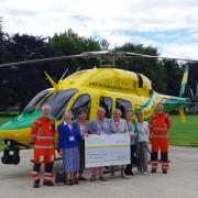 The Flower Ladies of St Mary's Church, Steeple Ashton present the cheque to Wiltshire Air Ambulance staff