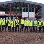 Members of Wiltshire Air Ambulance’s 100 Club at the charity’s new airbase under construction at Outmarsh Farm, Semington