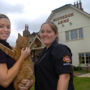 Ember the cat has been barred from the Blunsdon Arms, pictured with Kellie Watkins and Sarah Harrison