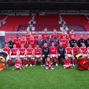 With the Swindon Town Football Club squad are Kevin Reed, Head of Operations at Wiltshire Air Ambulance, paramedic Steve Riddle and Wilber the mascot and paramedic Jo Munday