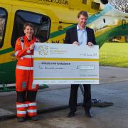 Excalibur CEO Peter Boucher hands over the cheque to the air ambulance