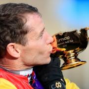 Richard Johnson kisses the Gold Cup after Native River's success at the Cheltenham Festival today