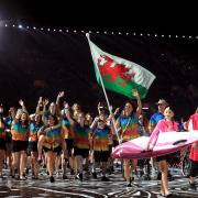 Swindon swimmer Jazz Carlin carries the Welsh flag as she leads out the team at today’s opening ceremony ahead of the Commonwealth Games, which get under way tomorrow
