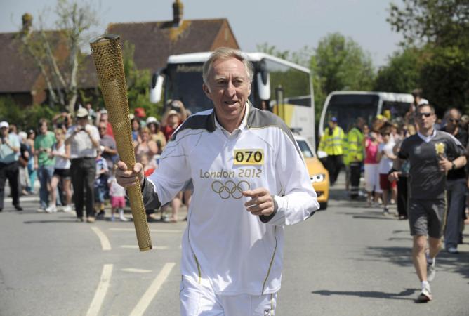 Your flame to fame. 
Readers' pictures capture memories of the Olympic Torch in town.
Former athlete David Hemery carrying the Olympic Flame on the leg between Royal Wootton Bassett and Swindon.