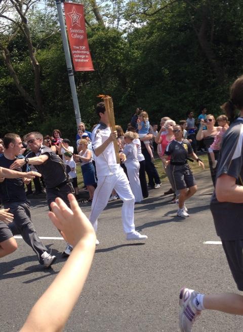 Your flame to fame. 
Readers' pictures capture memories of the Olympic Torch in town.
This picture was taken on great western way at about half two. It shows the teenager who attempted to grab the torch being tackled, before being thrown into a young fa