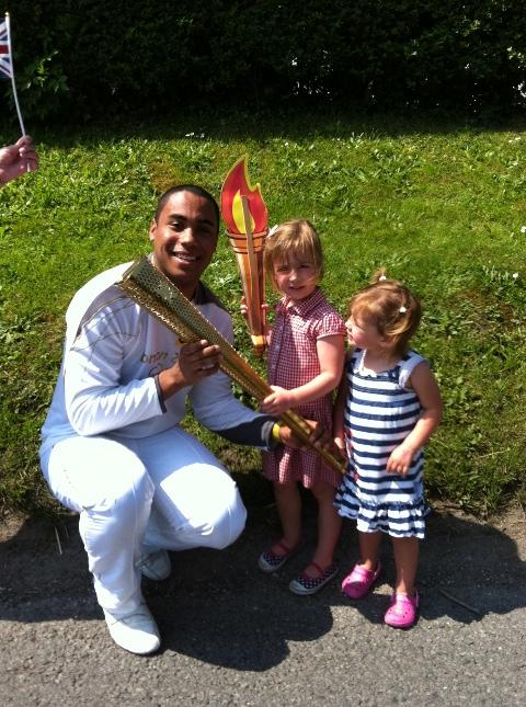 Your flame to fame. 
Readers' pictures capture memories of the Olympic Torch in town.  ''My two little girls with Carney Bonner in Chiseldon today'' - Polly Long
