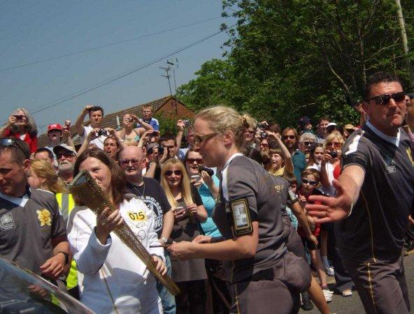 Your flame to fame. 
Readers' pictures capture memories of the Olympic Torch in town.
Lighting the torch at Kingshill - Luke Dawson,30.