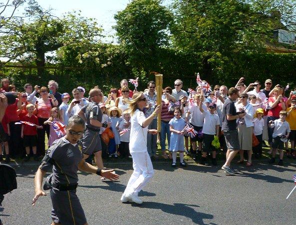 Your flame to fame. 
Readers' pictures capture memories of the Olympic Torch in town.
School children watch Olympic Torch in Chiseldon.