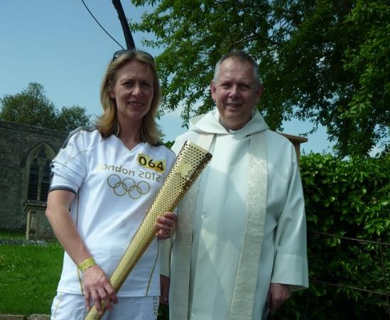 Your flame to fame. 
Readers' pictures capture memories of the Olympic Torch in town.
Becci Berry and Rev David Williams at Coleshill Village Olympic blessing - Picture Mair Hubband