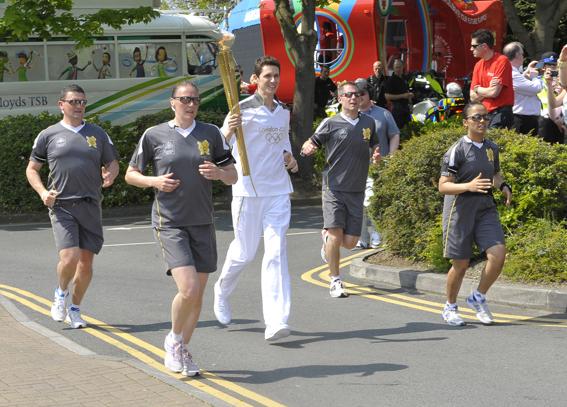 Thousands bask in the sun enjoying the spectacle of the Olympic Torch