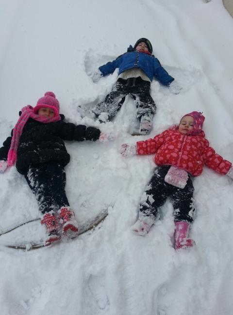 Ayla Edginton age four, Rhys Silvanus age four and Scarlett Silvanus age two making lovely snow angels