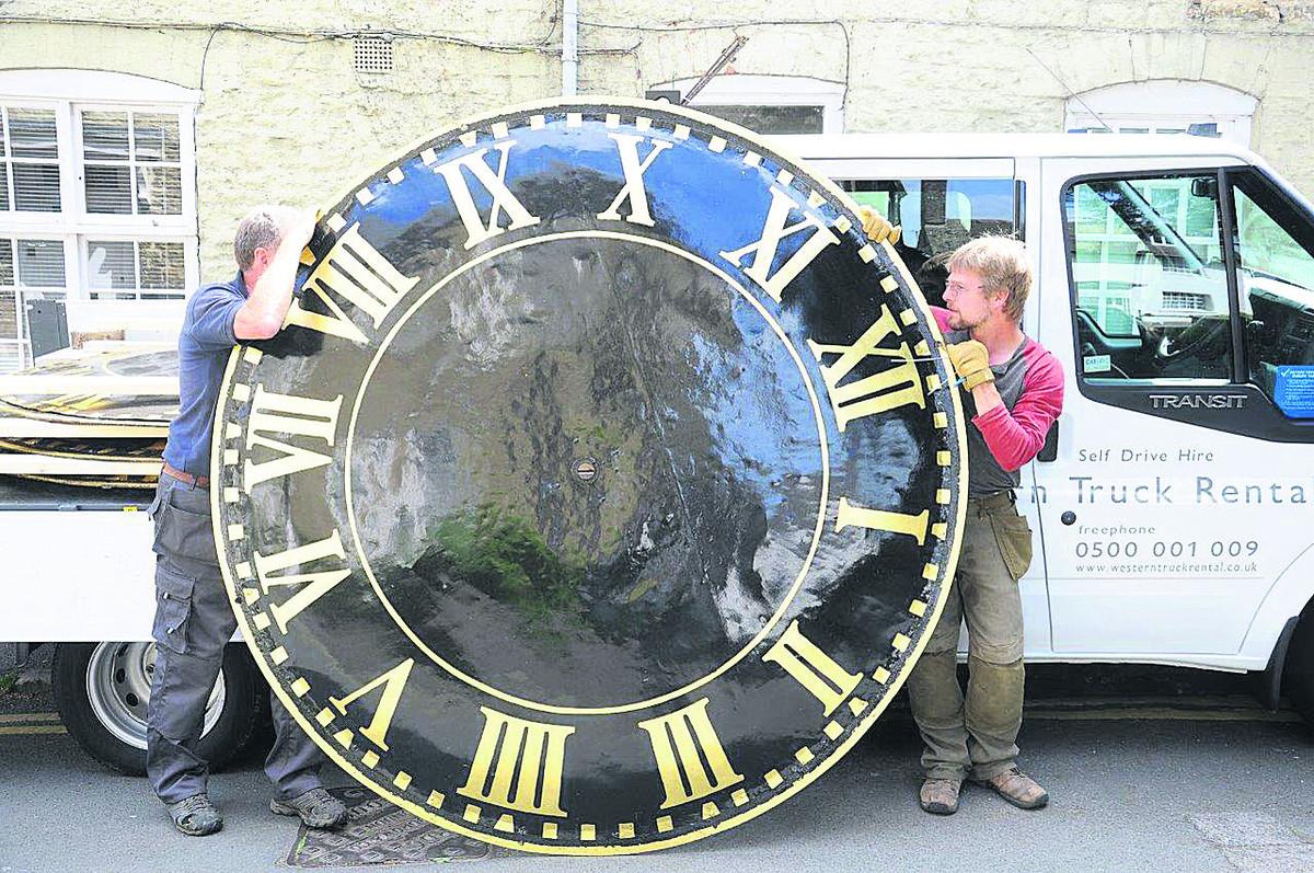 The repainted faces of Highworth Church clock tower are delivered back to the church.