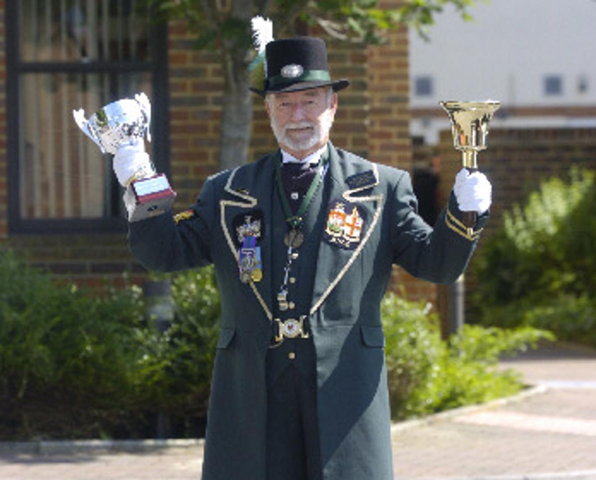 Fred 2006: Town Cryer Fred Ferris with the award he recently won for being the best dressed town crier. Here wearing his new suit. 