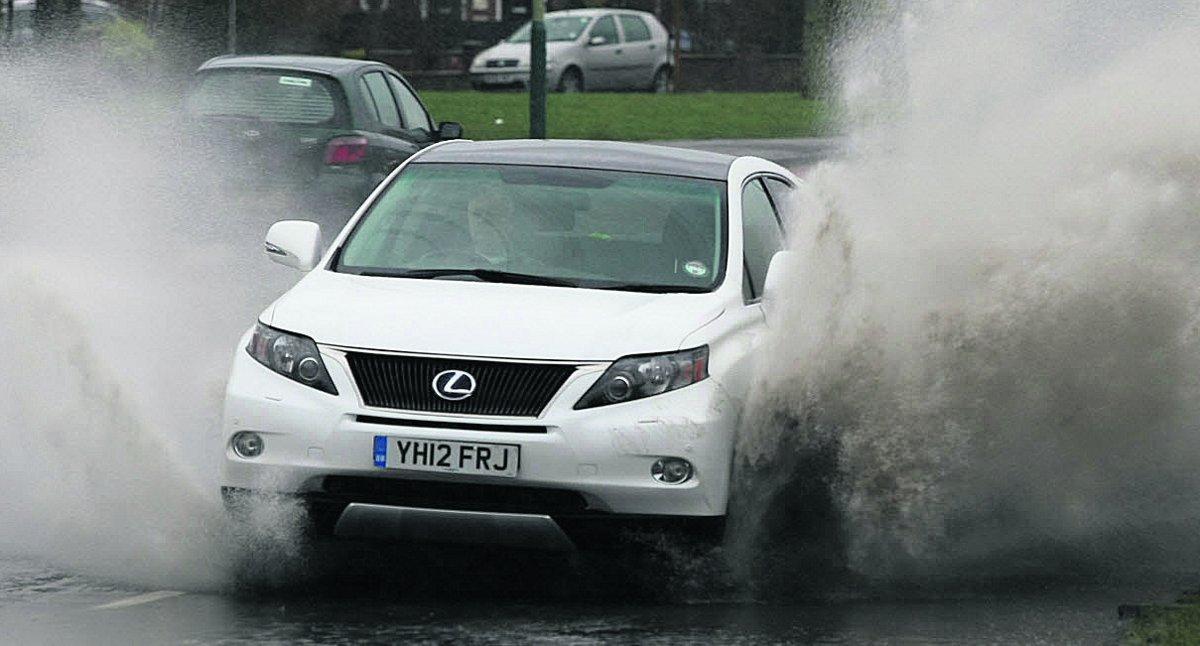 A car makes it through the flooding in Queens Drive  	                        Picture: STUART HARRISON