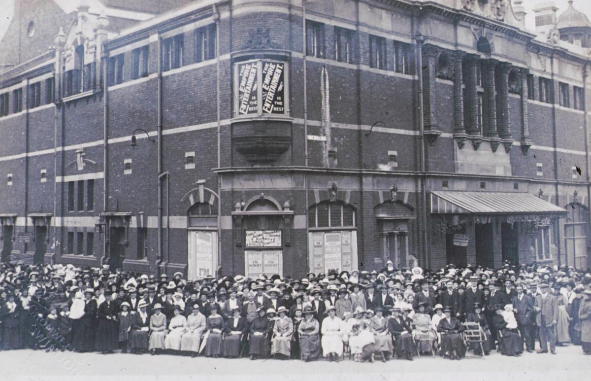 The audience poses for a photograph after a show at the Empire Theatre. Sales of the photograph would raise funds for the war effort.
