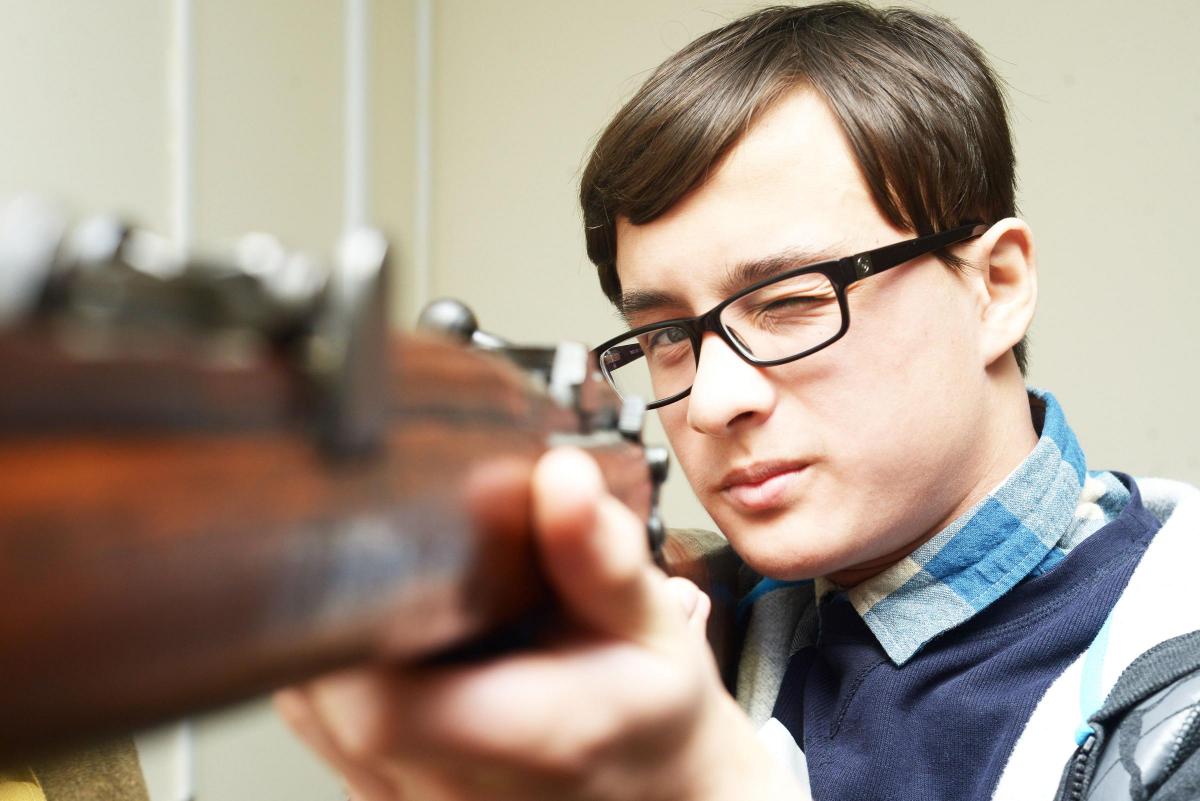 Pictured: Chandler from Nova Hreod School looking down the barrel of rifle