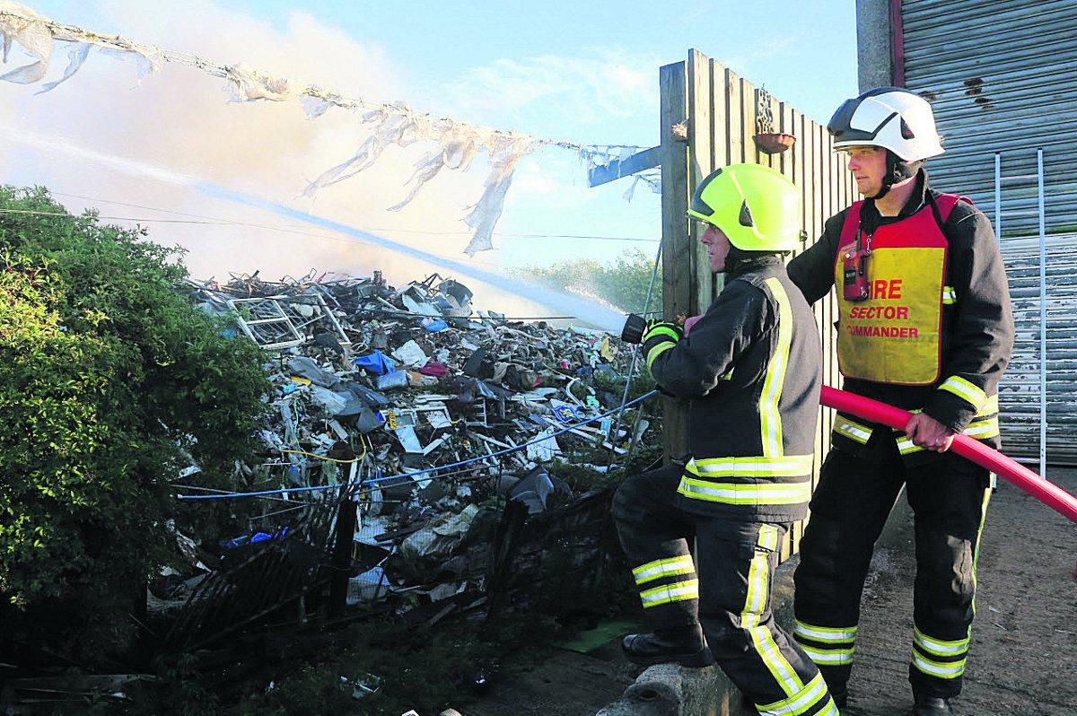 Frefighters swathed in smoke as he tackles the blaze t Averies Recycling at Marshgate