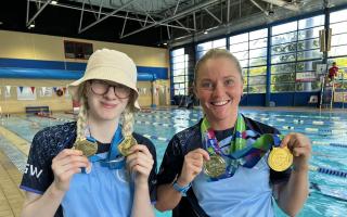 Swindon ASC Para swimmers Suzanna Hext (right) and Ella Williams hold up their respective medals