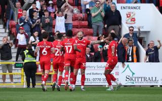 Swindon players celebrate the third goal