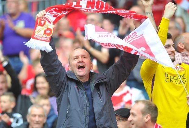 A Swindon Town fan keeps cheering