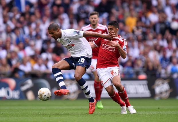 Preston North End's Jermaine Beckford (left) and Swindon Town's Massimo Luongo battle for the ball