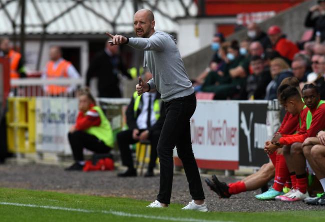 Swindon Town head coach Ben Garner points out instructions to his team in a recent home game Photo: Rob Noyes