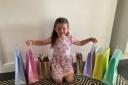 Six-year-old Thea Brunton with the goody bags she made to help make children happy Photo: Hayley Brunton