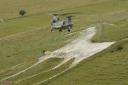 A heavy lift helicopter drops Chinook drops the tonne bags of Chalk at the Alton Barnes White Horse Photo Trevor Porter