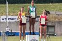 Swindon Harriers' Laila-Jae Belgrave stands on top of the podium after her win at the South West Schools Track and Field Championships at the Exeter Arena